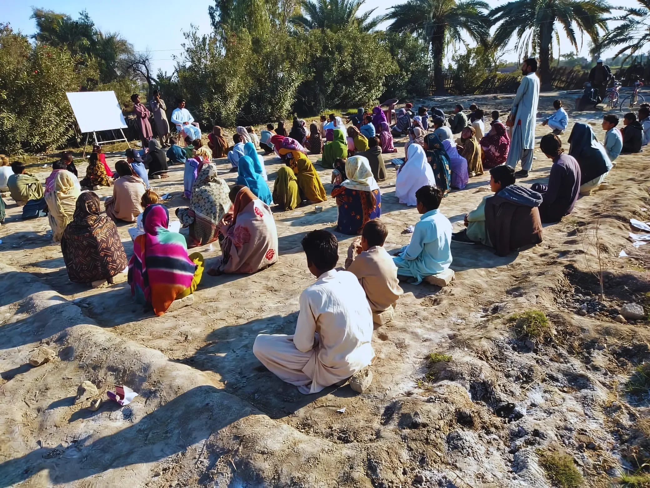 A group of young people outside, listening to a presentation