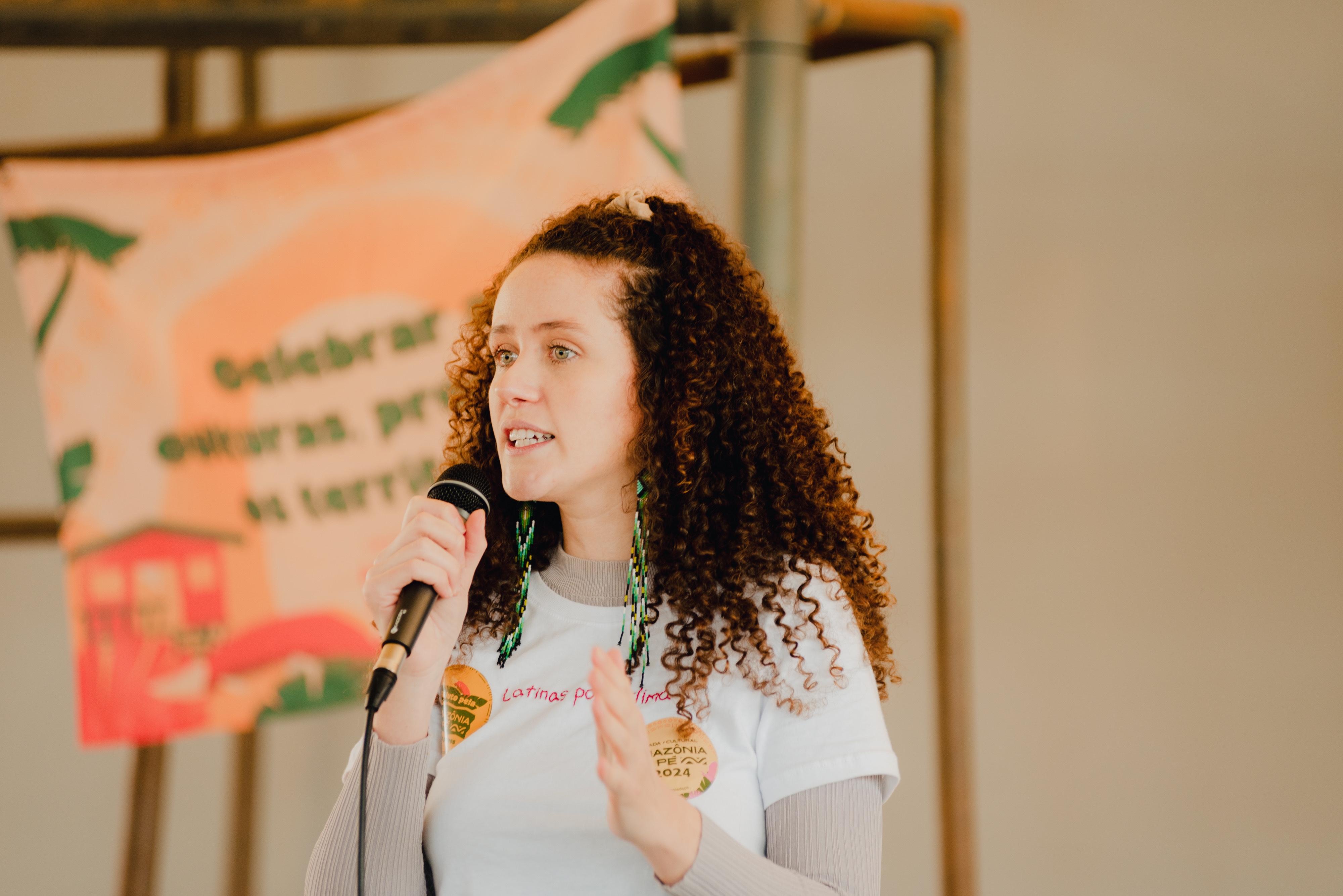 Woman holding a microphone and talking to public